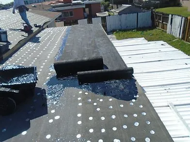 Waterproofing membrane being applied to a commercial flat roof in Tampa
