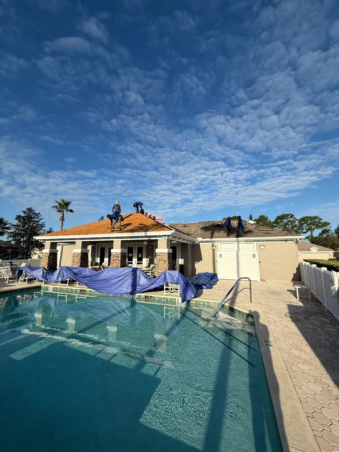 Commercial property with a tile roof and pool being maintained in Sarasota