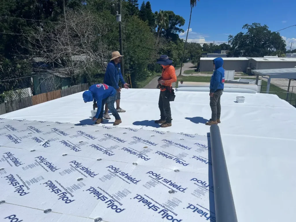 Crew making flat roof repairs on a Tampa commercial building